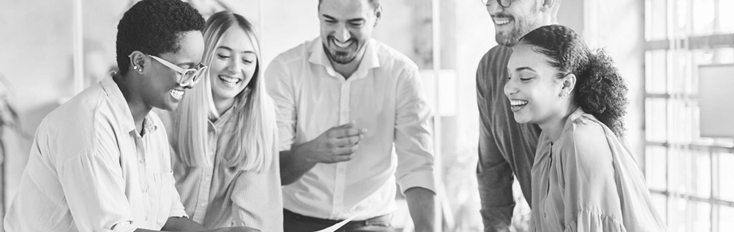 ESS Corporate Team Background Hero Faded background of five professionally dressed and culturally diverse adults cheerfully collaborating at their workplace